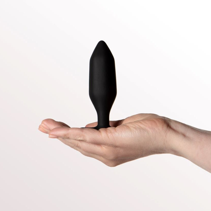 Hand holding Onyx Butt plug in black