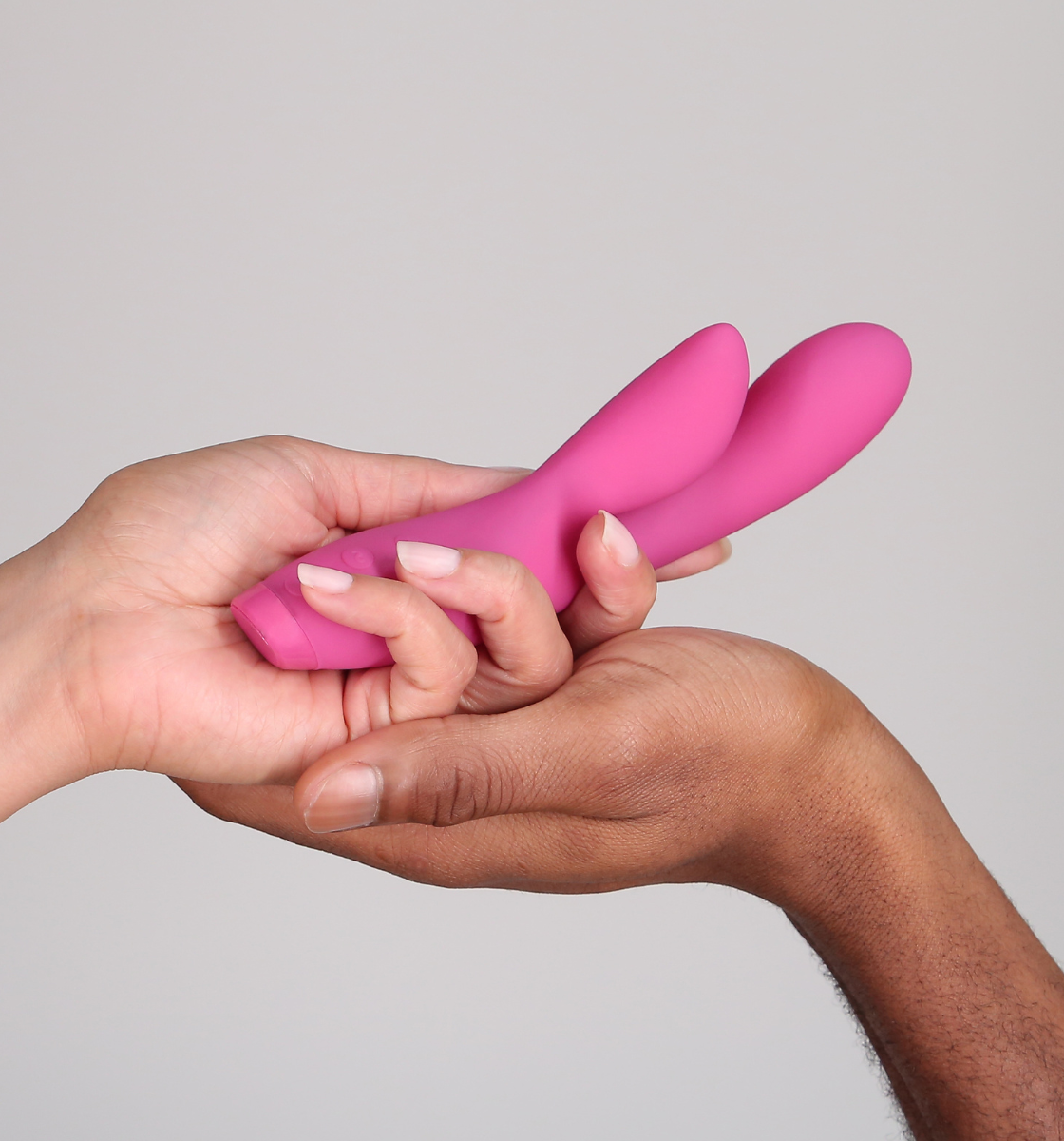 Hands holding Hera Rabbit Vibrator in pink 