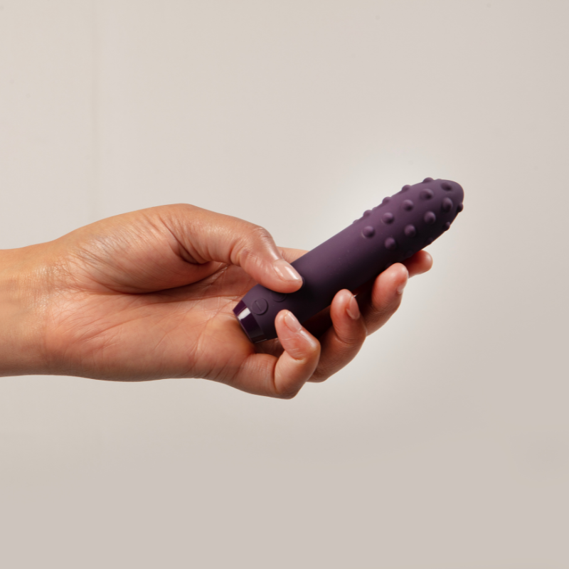 Hand holding purple Duet Bullet Vibrator