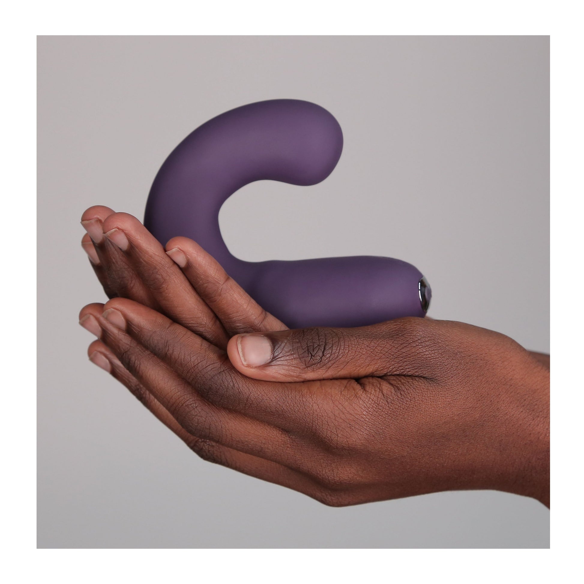 Hands holding G Kii Vibrator in purple