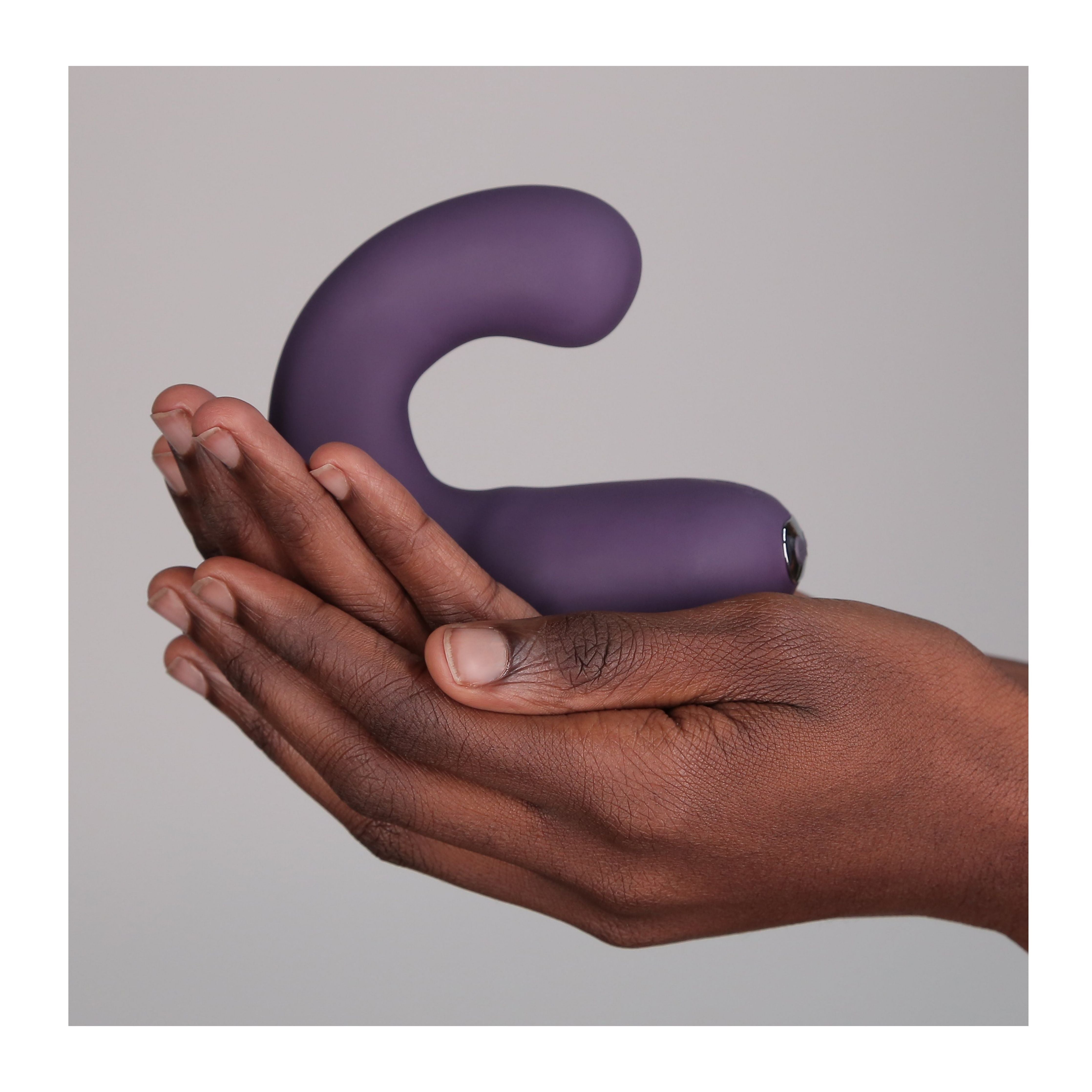 Hands holding G Kii Vibrator in purple
