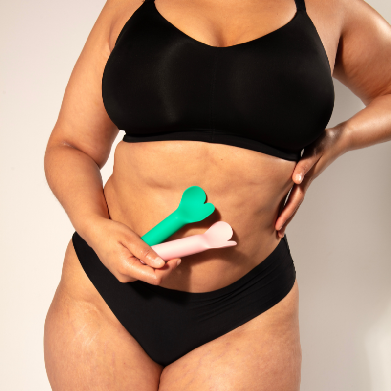Woman's body holding two Amour vibrators