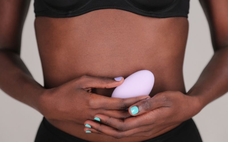 Woman holding Mimi Vibrator in front of torso