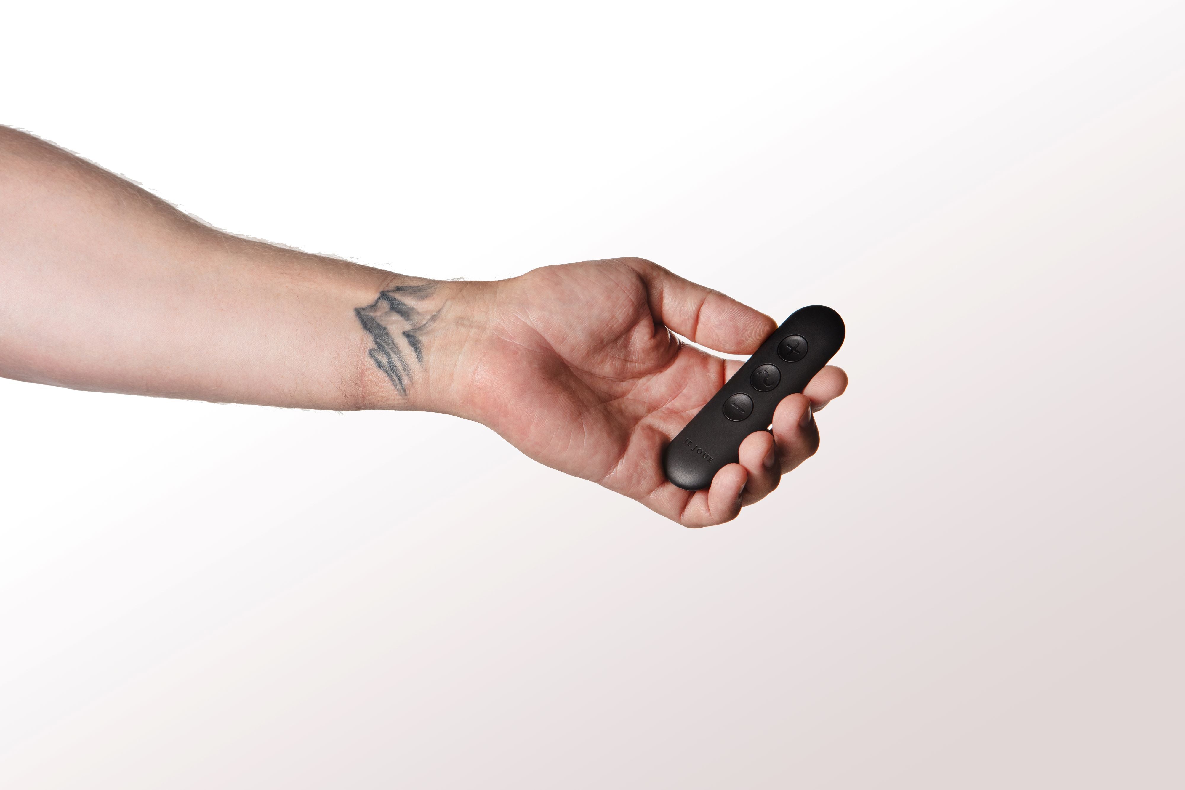 Hand holding Egon remote control