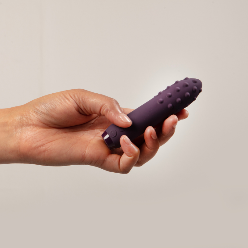 Hand holding purple Duet Bullet Vibrator 
