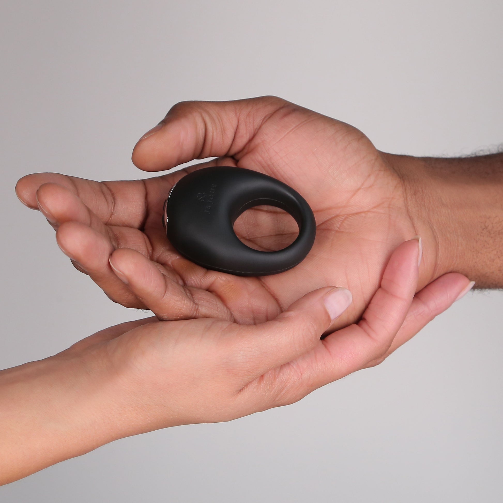 Hands holding Mio Vibrating Cock Ring