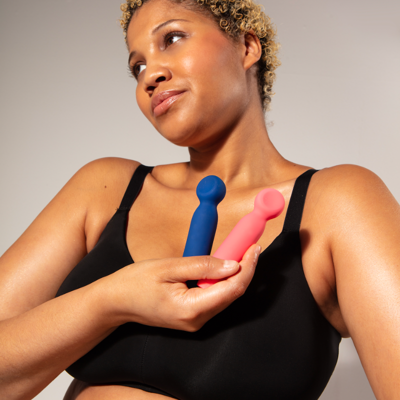 Woman holding to Vita vibrators in front of chest