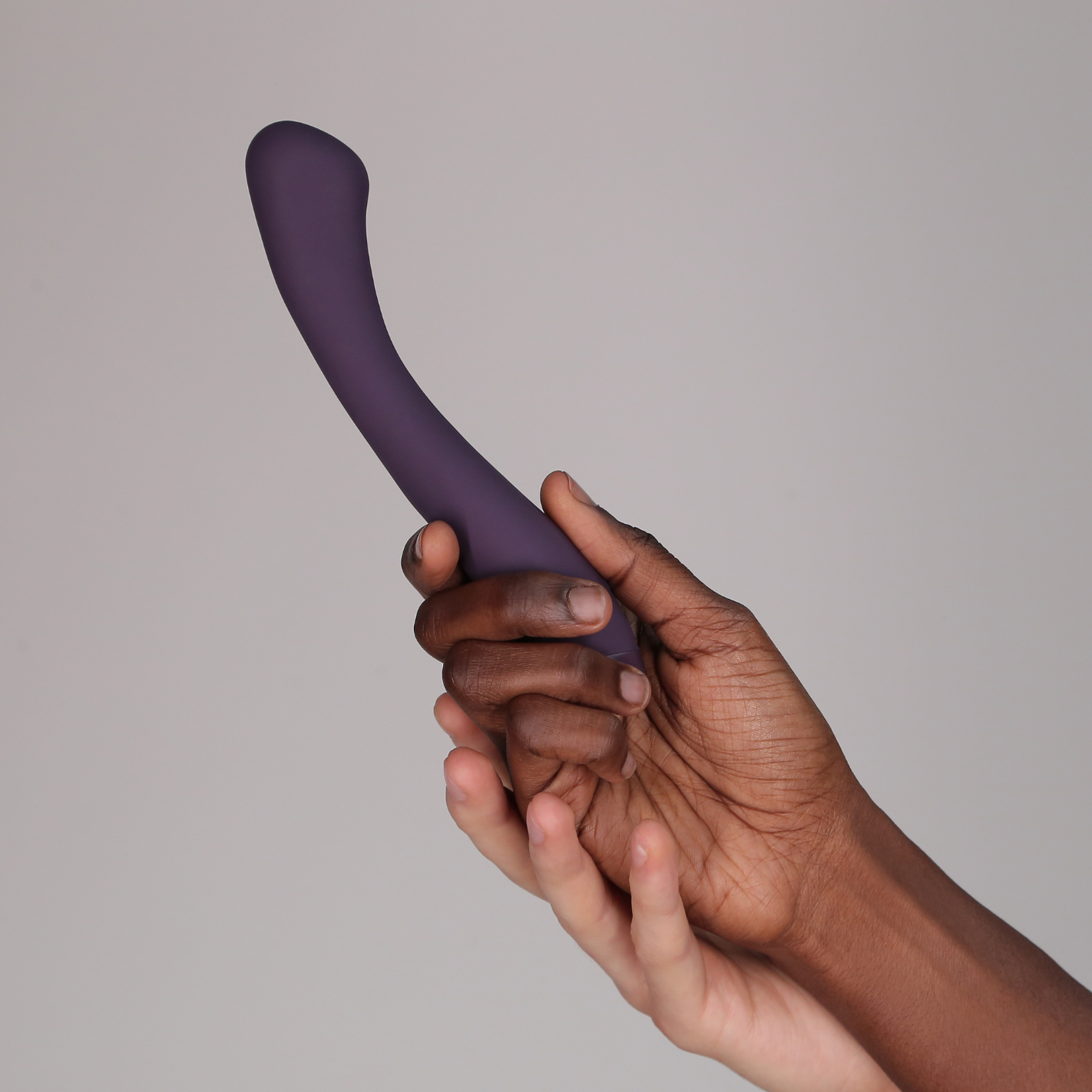 Hands holding purple Juno vibrator
