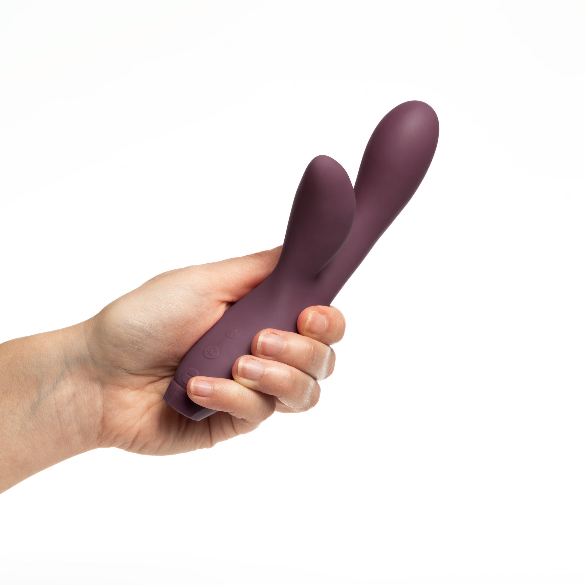 Hand holding Purple Hera Vibrator on white background 