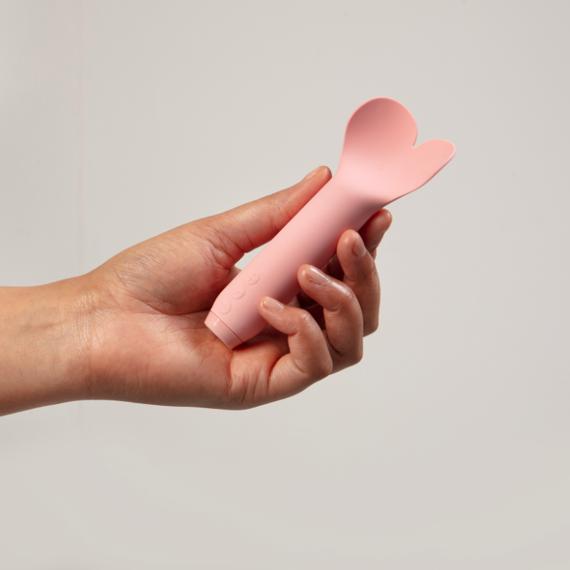Hand holding Amour bullet vibrator in pink